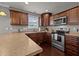 Kitchen featuring stainless steel appliances, recessed lighting, dark cabinets, and a view to the backyard at 5321 Longspur Dr, Snow Camp, NC 27349