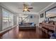 Bright and airy living room with hardwood floors, gray walls, ceiling fan, and view to the dining room at 5321 Longspur Dr, Snow Camp, NC 27349