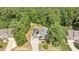 Aerial view of a charming single-Gathering home with solar panels and lush green landscaping at 6512 Blalock Forest Dr, Willow Springs, NC 27592