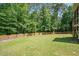 Spacious backyard featuring a well-maintained lawn, complemented by a classic wooden fence at 6512 Blalock Forest Dr, Willow Springs, NC 27592
