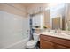 Cozy bathroom with a tub-shower combination, vanity with storage, and decorative accents at 6512 Blalock Forest Dr, Willow Springs, NC 27592