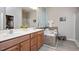 Bright bathroom features dual vanity, soaking tub with tile surround, and glass enclosed shower at 6512 Blalock Forest Dr, Willow Springs, NC 27592