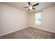 Bright, carpeted bedroom featuring a window with nature views and a ceiling fan for comfort at 6512 Blalock Forest Dr, Willow Springs, NC 27592