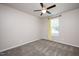 Neutral bedroom boasts carpet, ceiling fan, and window dressed with pale yellow curtains at 6512 Blalock Forest Dr, Willow Springs, NC 27592