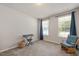 Well-lit bedroom with neutral walls, carpeted floors, and two windows with views of the outdoors at 6512 Blalock Forest Dr, Willow Springs, NC 27592