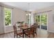 Elegant dining room featuring a wood table, large windows, and sliding glass doors to the outside at 6512 Blalock Forest Dr, Willow Springs, NC 27592