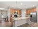 Bright kitchen with a large island, stainless steel appliances, and wood cabinetry at 6512 Blalock Forest Dr, Willow Springs, NC 27592