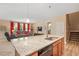 Open floor plan featuring a large kitchen island with a sink, granite countertops, and nearby living area at 6512 Blalock Forest Dr, Willow Springs, NC 27592