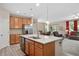 Open kitchen with stainless steel appliances, granite countertops, and a view into the living room at 6512 Blalock Forest Dr, Willow Springs, NC 27592