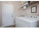 Laundry room featuring a white washer and dryer set, wire shelves and a white door at 6512 Blalock Forest Dr, Willow Springs, NC 27592
