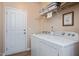 Functional laundry room equipped with modern appliances and storage shelving for convenience at 6512 Blalock Forest Dr, Willow Springs, NC 27592