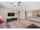 Open-concept living room with a view of the kitchen, a large TV, and a comfortable seating area at 6512 Blalock Forest Dr, Willow Springs, NC 27592