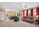 Spacious living room featuring plush seating, large windows, and an adjacent dining area at 6512 Blalock Forest Dr, Willow Springs, NC 27592