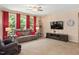 Comfortable living room showcasing a plush sofa, neutral tones, and a large TV for entertainment at 6512 Blalock Forest Dr, Willow Springs, NC 27592