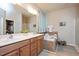 Bright main bathroom featuring double sinks, a soaking tub, and a separate glass-enclosed shower at 6512 Blalock Forest Dr, Willow Springs, NC 27592