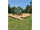 Community playground area with play structures for , surrounded by lush trees at 6512 Blalock Forest Dr, Willow Springs, NC 27592