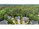 An aerial view shows the home's placement on a wooded lot with an attached two-car garage at 6728 Pointe Vista Cir, Raleigh, NC 27615