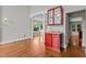 Convenient bar area with sink, wood cabinets, and glass shelving in an open floorplan space at 6728 Pointe Vista Cir, Raleigh, NC 27615
