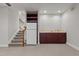 Finished basement with kitchenette, wine rack, fridge, and staircase at 6728 Pointe Vista Cir, Raleigh, NC 27615