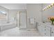 Bathroom featuring double vanity, bathtub, and separate shower at 6728 Pointe Vista Cir, Raleigh, NC 27615