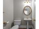 Traditional half bathroom features a pedestal sink, oval mirror, and gold fixtures at 6728 Pointe Vista Cir, Raleigh, NC 27615