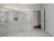 Bathroom featuring double sinks with ample counter space, gold hardware, and a decorative floral arrangement at 6728 Pointe Vista Cir, Raleigh, NC 27615