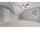 Neutral bedroom showcasing a ceiling fan, window with natural light, and closet door at 6728 Pointe Vista Cir, Raleigh, NC 27615