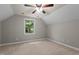 Bedroom showcasing a ceiling fan, neutral carpet, and a window providing natural light at 6728 Pointe Vista Cir, Raleigh, NC 27615