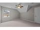 Neutral bedroom with carpeting, window, ceiling fan, and closet at 6728 Pointe Vista Cir, Raleigh, NC 27615