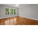 Bedroom featuring hardwood flooring and large windows at 6728 Pointe Vista Cir, Raleigh, NC 27615