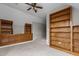 Carpeted bedroom with built in shelves, cabinets, and stairs leading down to another room at 6728 Pointe Vista Cir, Raleigh, NC 27615