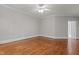 Spacious bedroom featuring hardwood flooring, ceiling fan, and natural light at 6728 Pointe Vista Cir, Raleigh, NC 27615