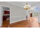 Bright dining room with hardwood floors and a modern chandelier at 6728 Pointe Vista Cir, Raleigh, NC 27615