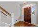 Bright foyer featuring hardwood floors, a decorative front door and stairs leading upstairs at 6728 Pointe Vista Cir, Raleigh, NC 27615