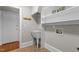 Well-organized laundry room includes a utility sink, shelving, and access to the exterior at 6728 Pointe Vista Cir, Raleigh, NC 27615