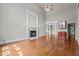 Bright open-concept living room features hardwood floors, fireplace, and adjoining bar area at 6728 Pointe Vista Cir, Raleigh, NC 27615