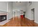 Spacious living room featuring hardwood floors, fireplace, and an adjacent bar area at 6728 Pointe Vista Cir, Raleigh, NC 27615