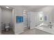 Spacious bathroom featuring double sinks, a glass-enclosed shower, and bright natural light at 708 Comice Pear Way, Willow Springs, NC 27592