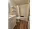 Bathroom showcases a vanity with lots of storage space and a tub shower at 7719 Kingsberry Ct, Raleigh, NC 27615