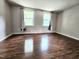 Spacious bedroom with great natural light and warm wood-look flooring at 7719 Kingsberry Ct, Raleigh, NC 27615