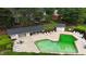 Aerial view of community pool with lounge chairs and sunbathing area surrounded by green space at 7719 Kingsberry Ct, Raleigh, NC 27615