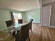 Dining room with wood floors, sliding glass door, and a table with four chairs at 7719 Kingsberry Ct, Raleigh, NC 27615