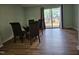 Dining room with wood floors, a sliding glass door and a modern glass-top dining table at 7719 Kingsberry Ct, Raleigh, NC 27615