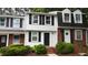 Charming two-story townhome with black shutters, a black door, and brick accents at 7719 Kingsberry Ct, Raleigh, NC 27615