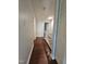 Upstairs hallway with wood-look flooring and natural light at 7719 Kingsberry Ct, Raleigh, NC 27615