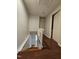 Open hallway with stairs leading down and doors leading to bedrooms at 7719 Kingsberry Ct, Raleigh, NC 27615