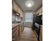 Efficient kitchen with stainless steel appliances and wooden cabinets offering ample storage at 7719 Kingsberry Ct, Raleigh, NC 27615