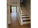 Inviting living room area featuring a staircase and sliding glass doors to the deck at 7719 Kingsberry Ct, Raleigh, NC 27615