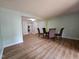 Spacious living room featuring wood floors, a dining area, and neutral paint at 7719 Kingsberry Ct, Raleigh, NC 27615