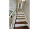 Ascending staircase features classic white risers and stained wood treads at 7719 Kingsberry Ct, Raleigh, NC 27615
